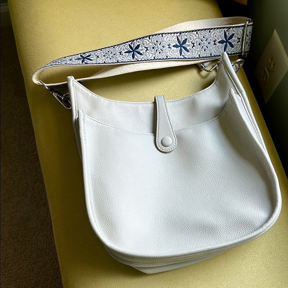ahdorned brand, crossbody cream color vegan leather bag.